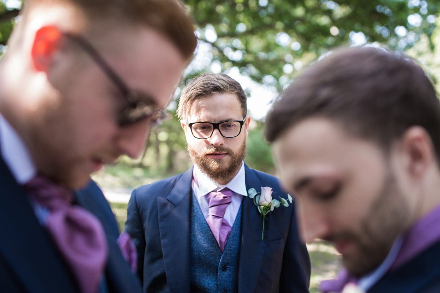 groom and his men prepare for the wedding outside a suffolk church 