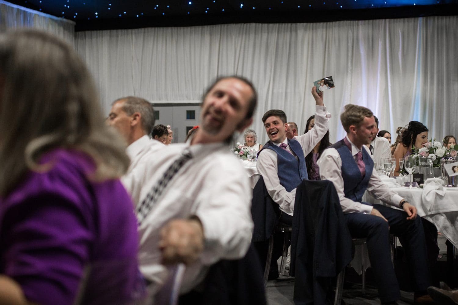 guest enjoy the speeches at a wedding in the hangar kesgrave hall 