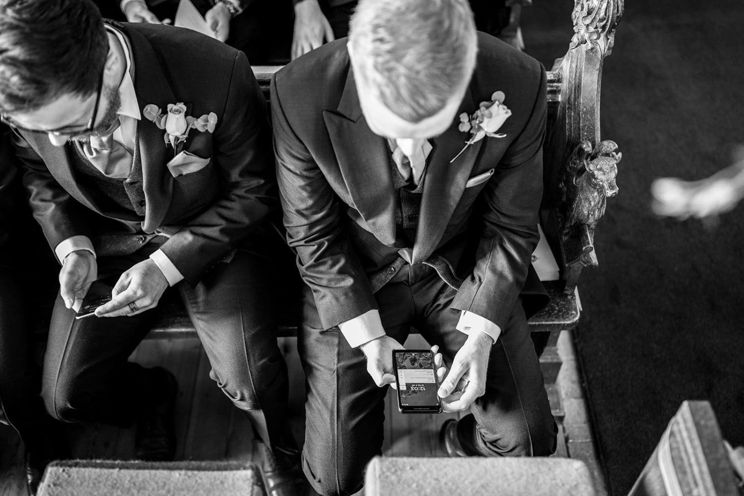groom nervously checks the time while waiting for his bride to arrive at his suffolk wedding