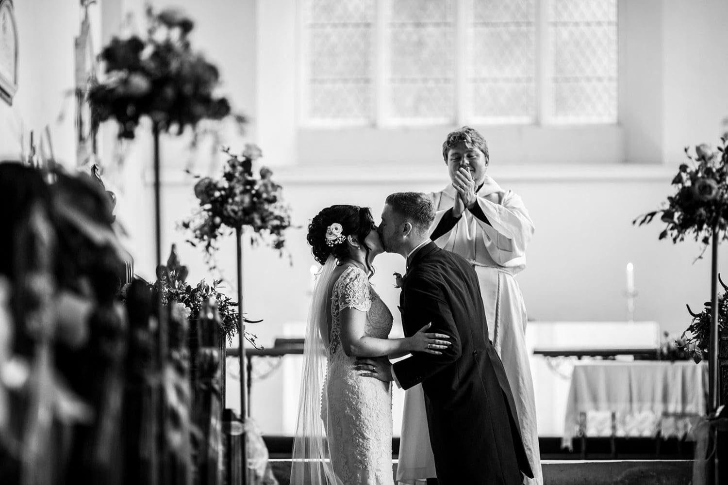 couple are applauded for their first kiss at their suffolk wedding