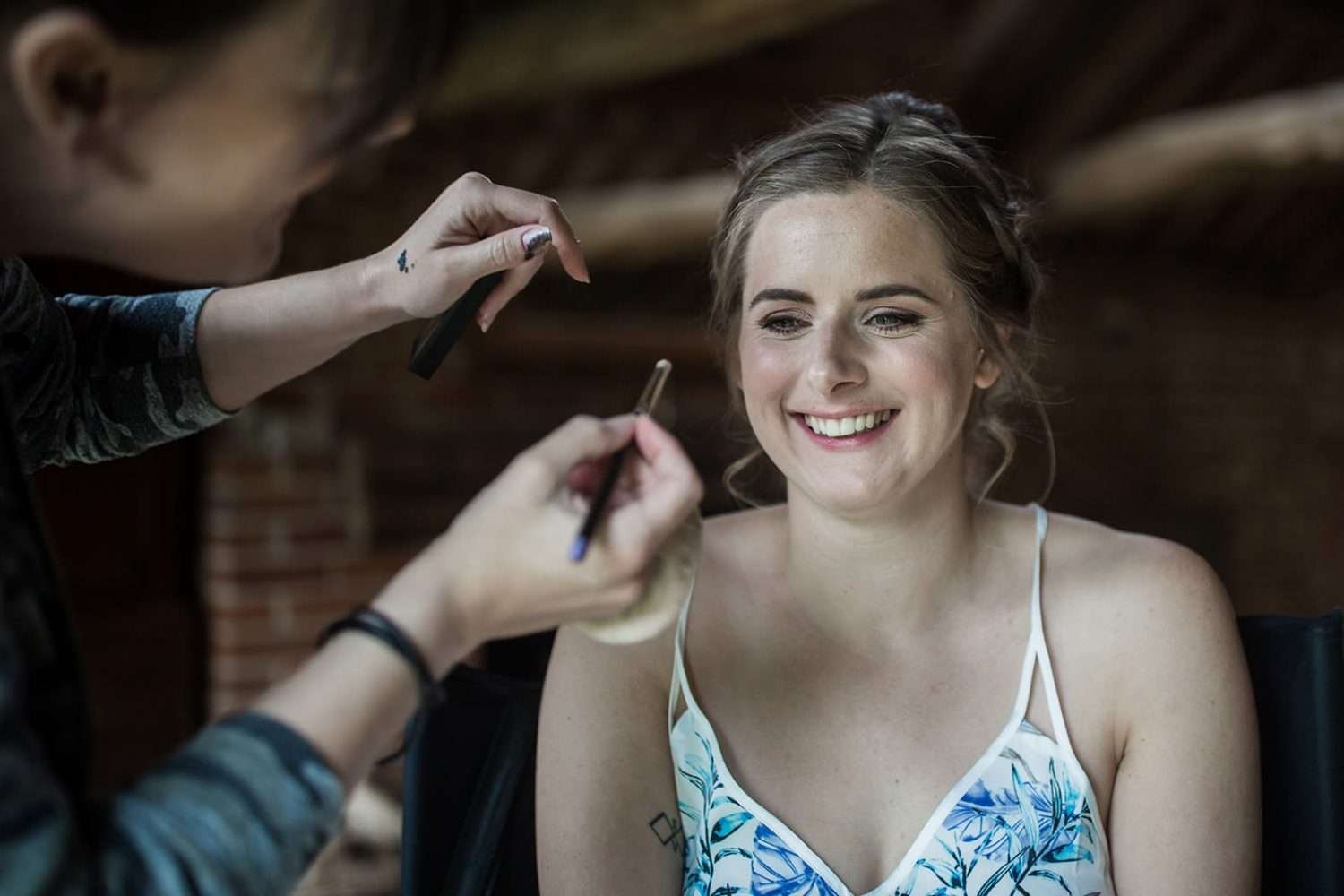 bride getting her meak up done on the morning of her wedding
