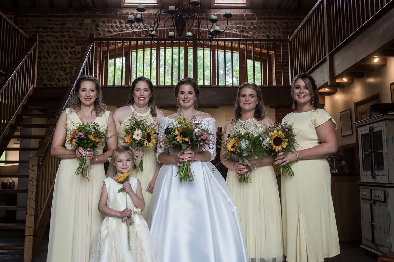 bride stands with her bridesmaids at her chaucer barn wedding