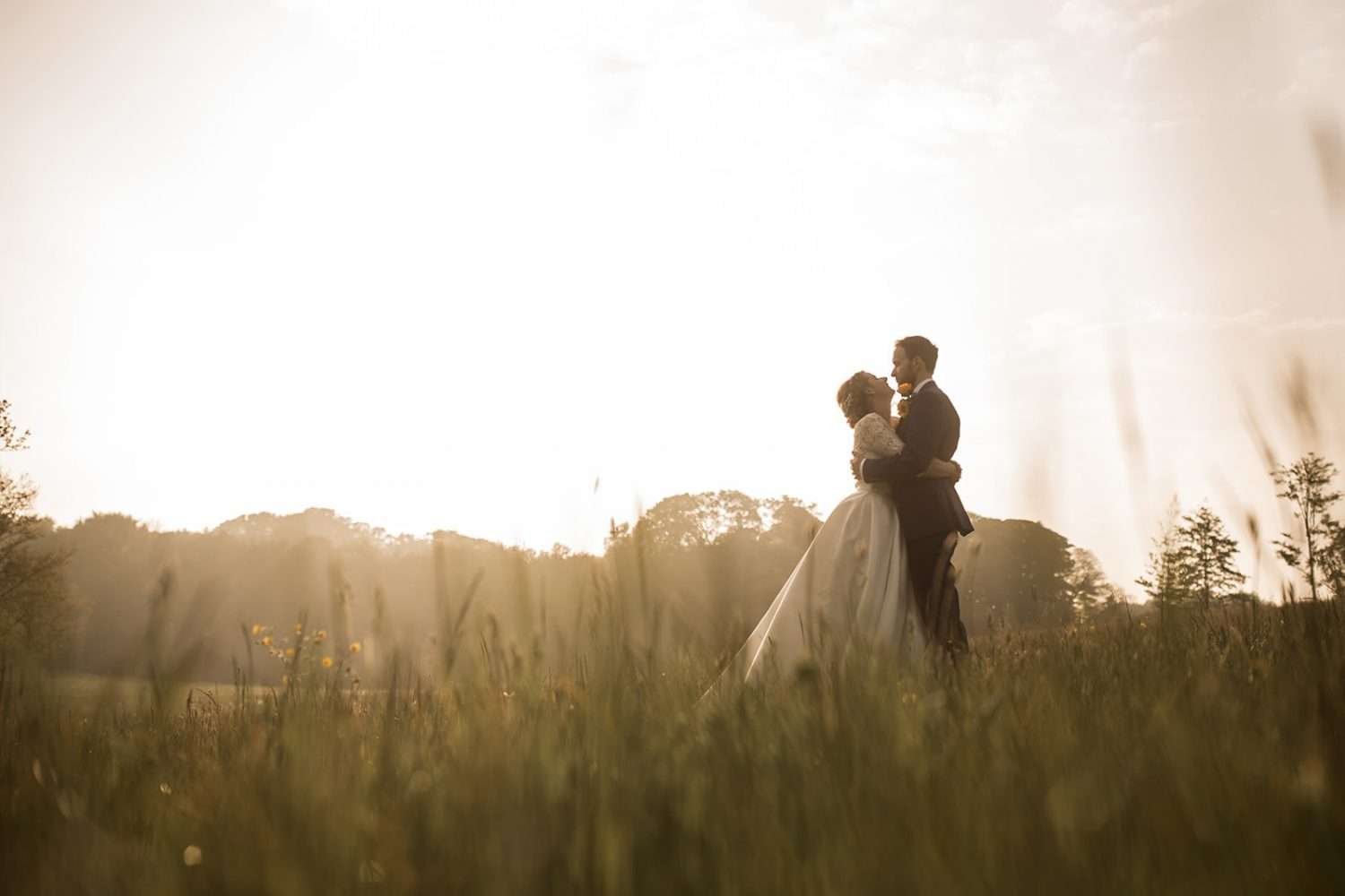 sunset at chaucer bard as a newly married couple kiss in the meadows