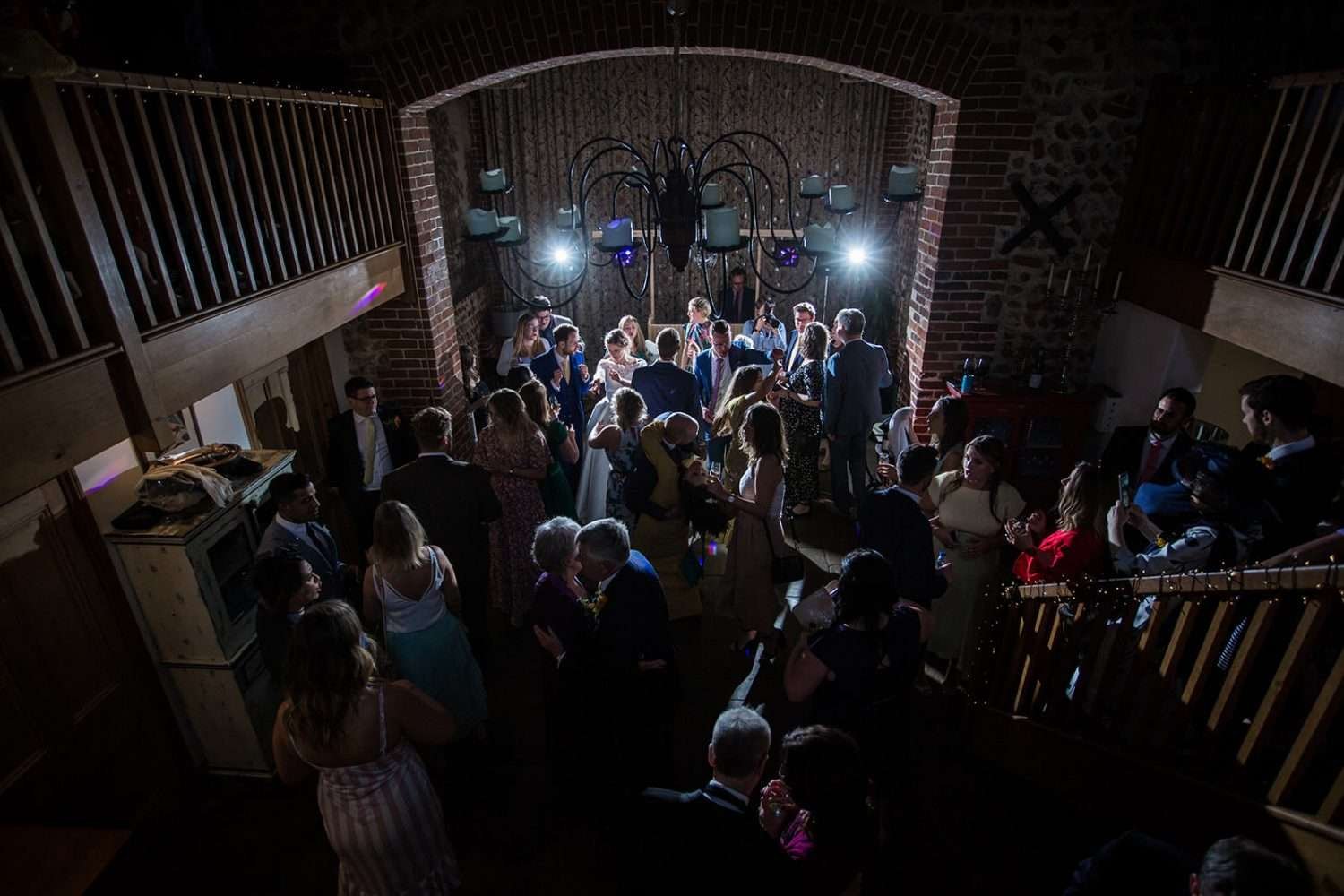 guests and couple dance and sing at a chaucer barn wedding in norfolk
