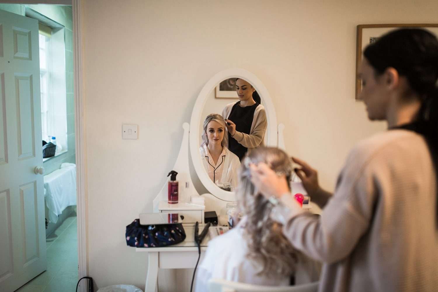 Bride having her make up done whilst getting ready at Henham Barn in suffolk 