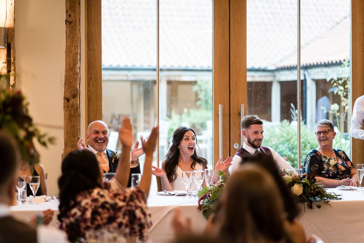 Top table at a wedding laugh and applaud at the end of the best mans speech. 
