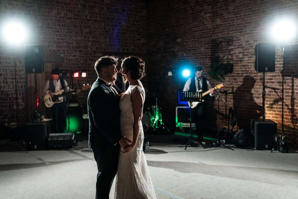 Bride and Groom enjoy their first dance in the hall at their Fishley Hall wedding 