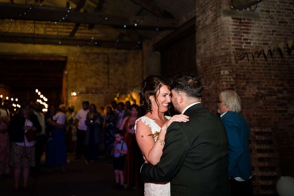 Bride and Groom enjoy their first dance in the hall at their Fishley Hall wedding
