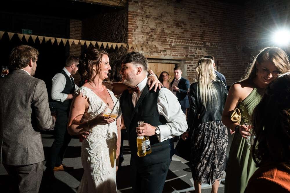 Bride and Groom enjoy dancing with their guests in the great barn at their Fishley Hall wedding