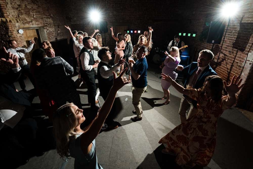 Bride and Groom enjoy dancing with their guests in the great barn at their Fishley Hall wedding