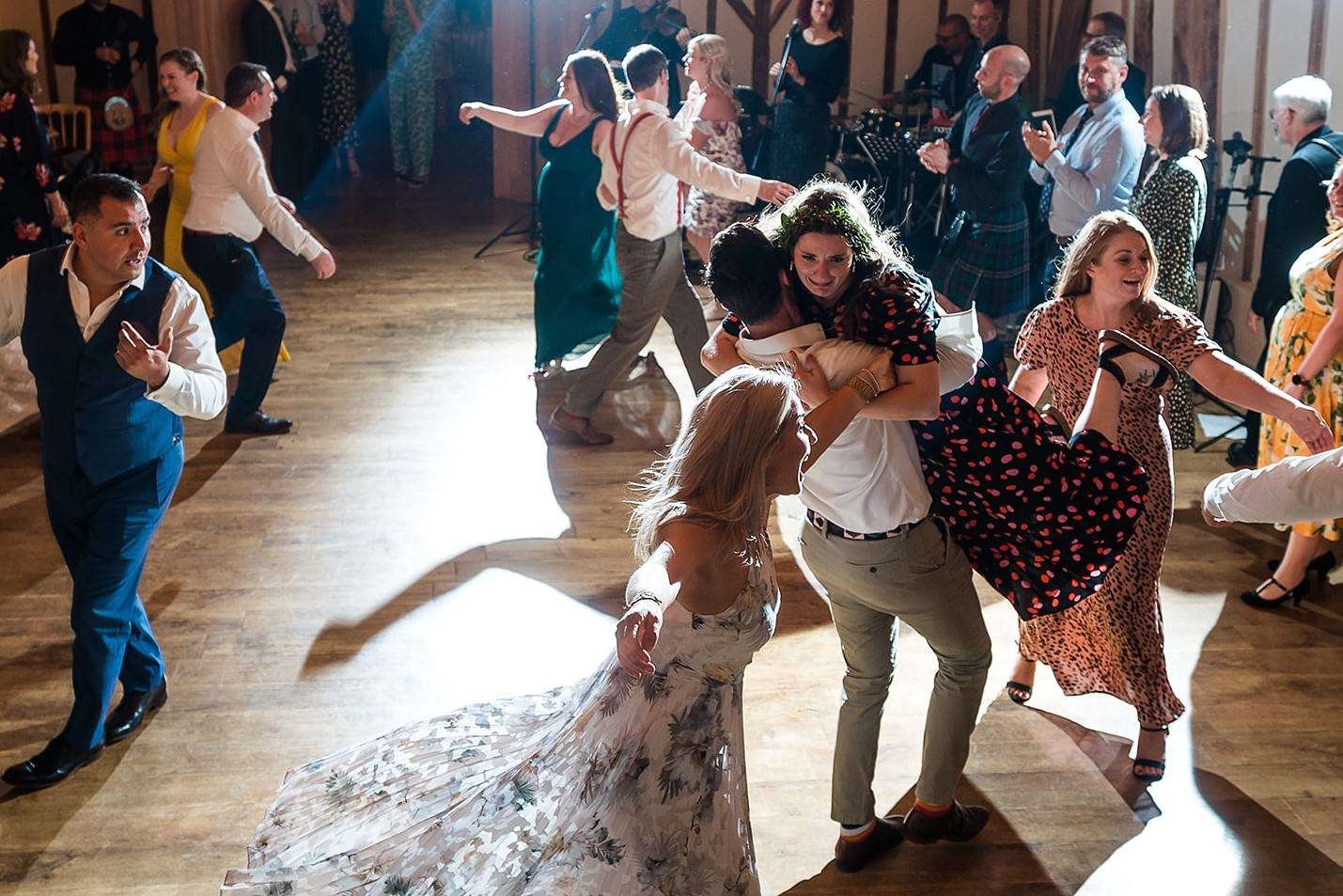 Happy dancing to a ceilidh band at a Bruisyard Hall wedding 