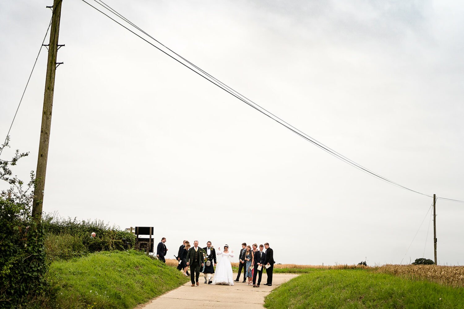 a wedding party and their guests move from the church 