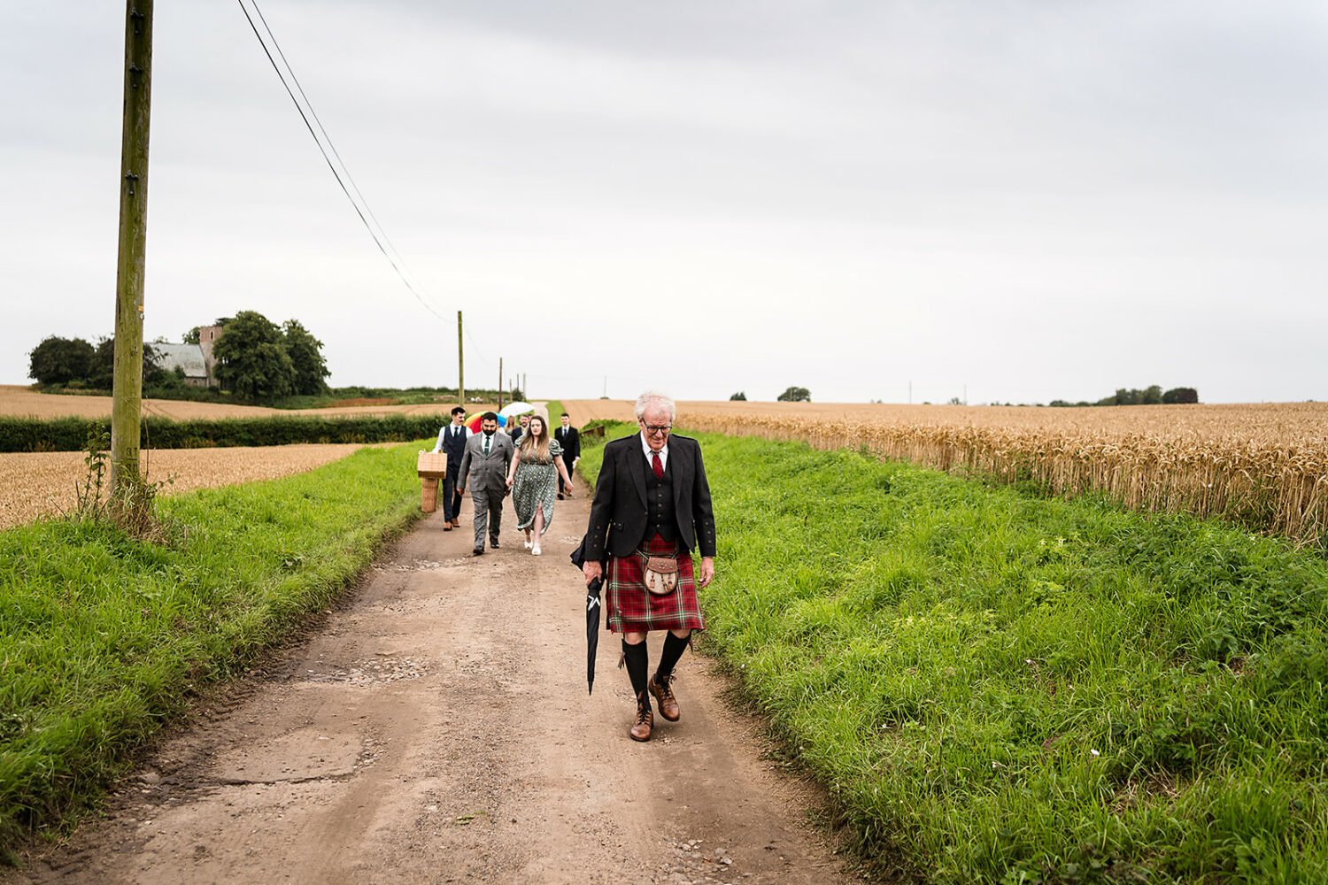a wedding party and their guests move from the church to fishley hall for the wedding reception. It's a long drive or walk in light rain. 