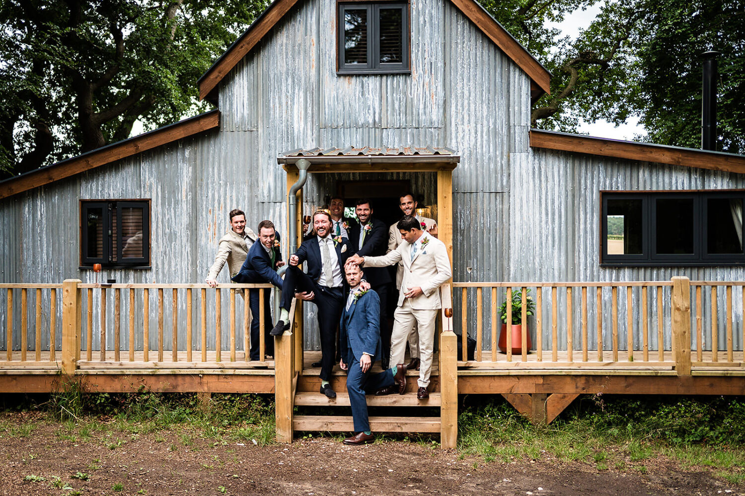 There's loads of on site and quirky guest accommodation at happy valley, here's the groom and his grooms men laughing just before the wedding ceremony by www.lisaandneil.co.uk