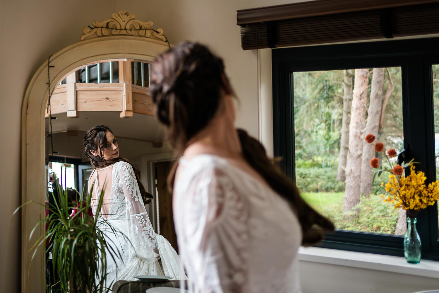 a last look in the mirror as the beautiful bride prepares for her happy valley wedding in Norfolk by Norfolk wedding photographers www.lisaandneil.co.uk