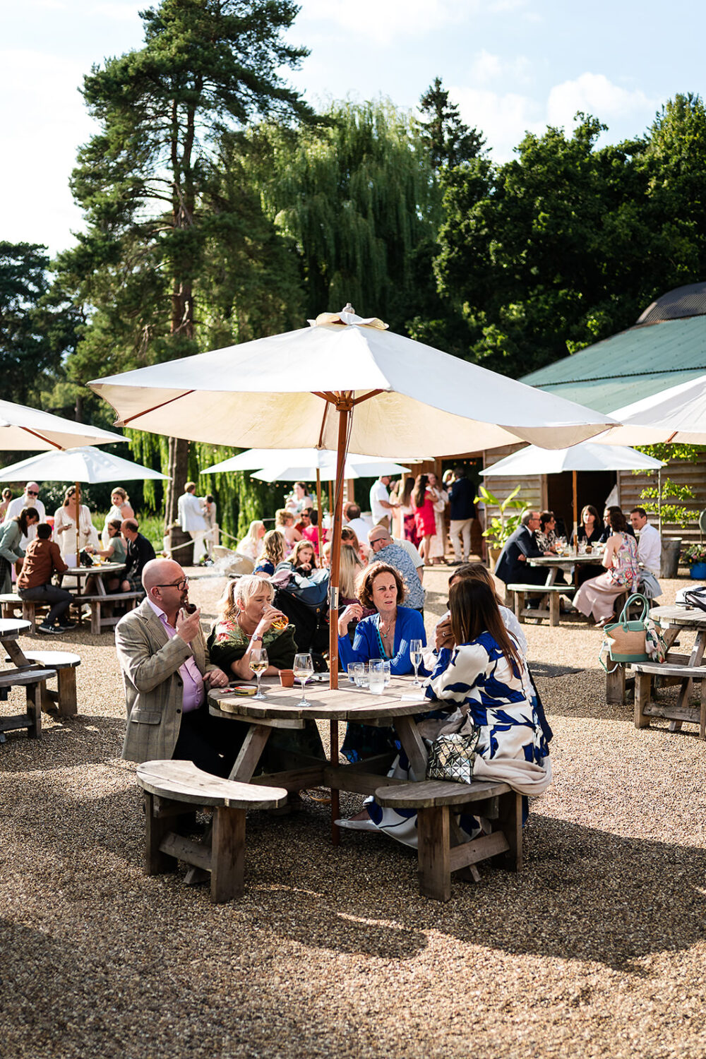 wedding guests relax in the outdoor bar and reception area at happy valley wedding venue by www.lisaandneil.co.uk