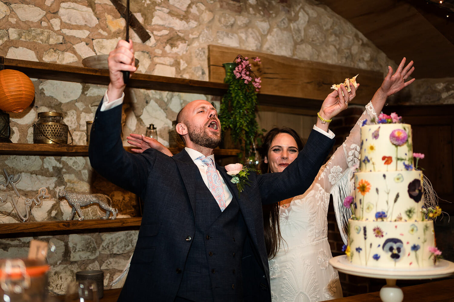 couple cutting their wedding cake at happy valley in the hay barn